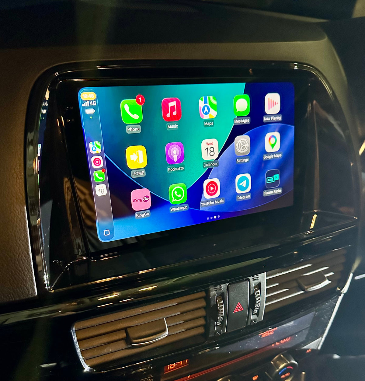 Close-up of the Mazda CX5 2012–2015 installed touchscreen displaying the Apple CarPlay app grid.
